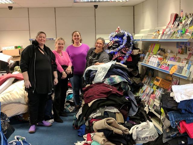 Photo of volunteers with collection for homeless