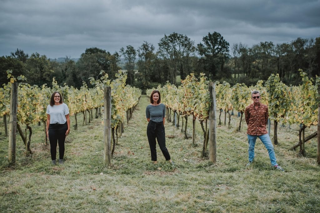 three people in vineyard