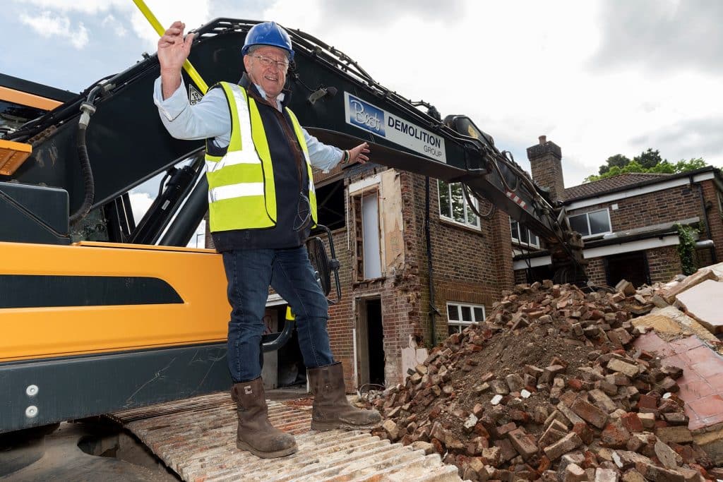 A man in front of a digger