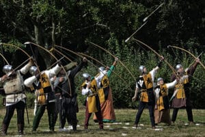 archers pulling back their bows in medieval costume