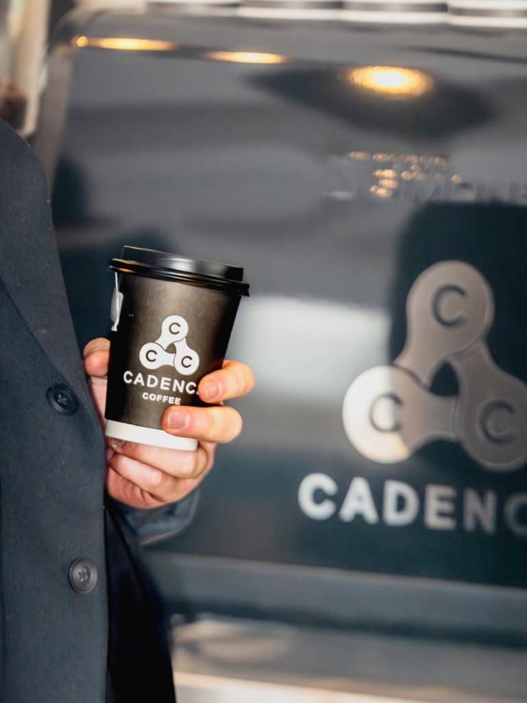 woman holding a cup of takeaway coffee